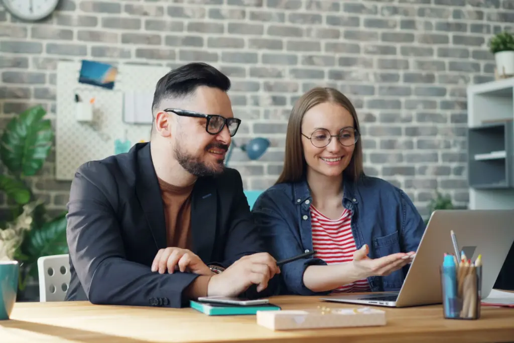 A couple review their credit information using a laptop