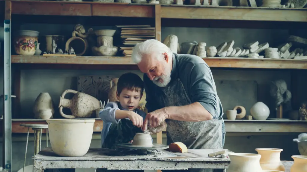 Grandfather and Grandson Making Pottery